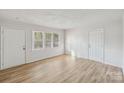 Bright living room with hardwood floors and neutral walls at 2016 Norwich Pl, Charlotte, NC 28208