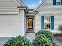 Front entrance with a wooden door and green shutters at 2532 Governors Pointe Ne Ct, Concord, NC 28025