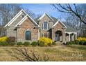 Beautiful two-story home featuring mixed brick and stone, an arched entry, and manicured landscaping at 4006 Sincerity Rd, Monroe, NC 28110