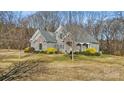 Charming home featuring a stone and gray brick exterior with a well-manicured lawn and mature trees at 4006 Sincerity Rd, Monroe, NC 28110