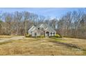 Well-maintained two-story home featuring manicured landscaping, mature trees, and an asphalt driveway at 4006 Sincerity Rd, Monroe, NC 28110