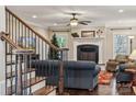 Living room with fireplace, hardwood floors, and a staircase at 4006 Sincerity Rd, Monroe, NC 28110