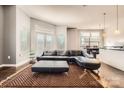 Open living area with leather sectional sofa and large windows at 525 E 6Th St # 409, Charlotte, NC 28202