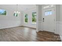 Inviting foyer featuring wood floors, bright natural light, and elegant trim at 5404 Verona Rd # 36, Charlotte, NC 28213
