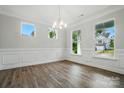 Bright and airy living room featuring stylish wood floors and large windows offering scenic views at 5404 Verona Rd # 36, Charlotte, NC 28213
