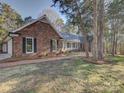 Brick home showcasing a brick walkway and lush greenery at 5529 Five Knolls Dr, Charlotte, NC 28226