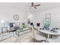 Bright living room with a gray couch and a dining area at 5633 Torrence St, Charlotte, NC 28269