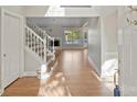 Bright and airy foyer with hardwood floors and a staircase at 6415 Outer Bridge Ln, Charlotte, NC 28270