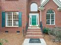 Brick front entrance with green door and brick steps at 810 Carisbrooke Ln, Waxhaw, NC 28173