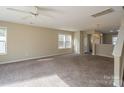 Bright living room with carpeted floors and access to kitchen at 13406 Tartarian Ct, Charlotte, NC 28215