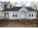 Gray house with a classic design and mature trees in the yard at 1909 2Nd Sw Ave, Hickory, NC 28602