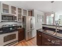 Modern kitchen with stainless steel appliances and dark wood cabinets at 509 N Graham St # 1G, Charlotte, NC 28202