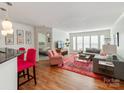 Open concept living space featuring hardwood floors and stylish furniture at 509 N Graham St # 1G, Charlotte, NC 28202