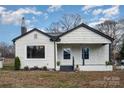 Charming single-story home with white siding, black trim and stone-accented porch at 5204 Dellinger Cir, Cherryville, NC 28021