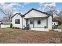 Well-maintained one-story home with white siding, black trim and stone-accented porch at 5204 Dellinger Cir, Cherryville, NC 28021