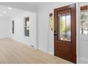 Bright entryway with hardwood floors and a wood door at 5910 Grosner Pl, Charlotte, NC 28211