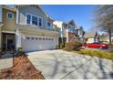 Townhome with attached garage and a red car parked nearby at 6132 Pale Moss Ln, Charlotte, NC 28269