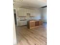 Spacious kitchen with white cabinets and light wood flooring at 7287 Gabriel St, Sherrills Ford, NC 28673