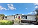 Mobile home with new wooden stairs and landscaping at 9763 Knightbridge Dr, Concord, NC 28025