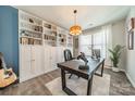 Home office with built-in shelves, a large desk, and a guitar at 112 Tetcott St, Mooresville, NC 28115