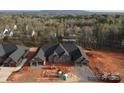 New construction brick home featuring a two-car garage on each side with a view of trees in the background at 3343 48Th Ne Ave # 15B, Hickory, NC 28601