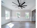 Inviting living room with hardwood floors, panelled walls, and large windows at 4739 Whispering Oaks Dr, Charlotte, NC 28213