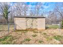 Tan wooden storage shed with double doors in backyard at 108 Landing Ct # 36, Bessemer City, NC 28016