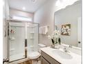 Bathroom features a glass shower enclosure, large mirror, white countertops, and neutral color palette at 1447 Honey Trl, Monroe, NC 28112