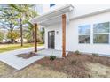 Cozy front porch with stained wood columns, modern lighting, and a welcoming entrance at 211 Chestnut St, Shelby, NC 28150