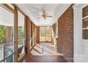 Cozy screened porch with brick floors and ceiling fan at 223 W 9Th St, Newton, NC 28658