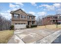 Two-story brick home with driveway and mature trees at 2548 Flintshire Ln, Gastonia, NC 28056