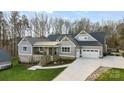 Gray craftsman style home with a two-car garage and nicely landscaped yard at 324 Patternote Rd, Mooresville, NC 28117