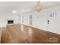 Spacious living room with hardwood floors, fireplace and white walls at 3453 Selwyn Ave, Charlotte, NC 28209