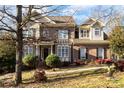 Two-story house with brick and siding exterior, and mature trees at 355 Sardis Rd N Alt Rd, Charlotte, NC 28270