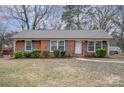 Brick ranch house with landscaped lawn and walkway at 4201 Westridge Dr, Charlotte, NC 28208