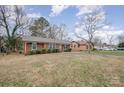 Front view of charming brick ranch home with yard at 4201 Westridge Dr, Charlotte, NC 28208