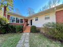 Charming home featuring brick accents and a cozy front entrance with steps and a welcoming wreath at 511 W Stevens Dr, Kershaw, SC 29067