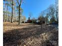 Lovely front lawn view of a home with a red brick chimney and mature trees on a sunny day at 511 W Stevens Dr, Kershaw, SC 29067