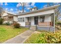 Quaint white bungalow home with a front porch at 526 S Green St, Statesville, NC 28677