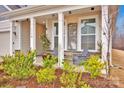 Inviting front porch with rocking chairs and landscaping at 132 N Shayna Rd, Troutman, NC 28166