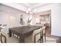 This dining room features an open-concept design with modern lighting and views to the kitchen and staircase at 1364 Cedardale Ln, Denver, NC 28037