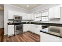 Modern kitchen with granite countertops and white cabinets at 1485 Adkin Dr, Iron Station, NC 28080