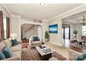 Inviting living room with plush seating, neutral colors, and seamless flow to the dining area at 1485 Adkin Dr, Iron Station, NC 28080