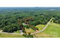 Aerial view of property with a red line denoting the property boundary and showing mature trees and surrounding nature at 1769 Old Nc 27 Hwy, Mount Holly, NC 28120