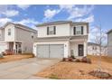 Two-story house with gray siding, double garage, and landscaping at 226 J.P. Dr, Albemarle, NC 28001