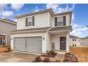 Two-story house with gray siding, double garage, and landscaping at 226 J.P. Dr, Albemarle, NC 28001