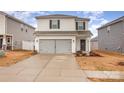 Two-story house with gray siding, double garage, and landscaping at 226 J.P. Dr, Albemarle, NC 28001