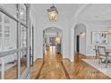 Elegant foyer with hardwood floors, arched doorways, and sophisticated lighting, creating a grand entrance to the home at 228 Heathwood Rd, Charlotte, NC 28211