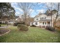 Two story house on a landscaped lawn with mature trees at 5022 Saybrook Dr, Harrisburg, NC 28075