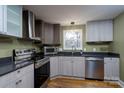 The updated kitchen boasts stainless steel appliances, sleek gray cabinetry, and ample counter space at 6726 Wannamaker Ln, Charlotte, NC 28226